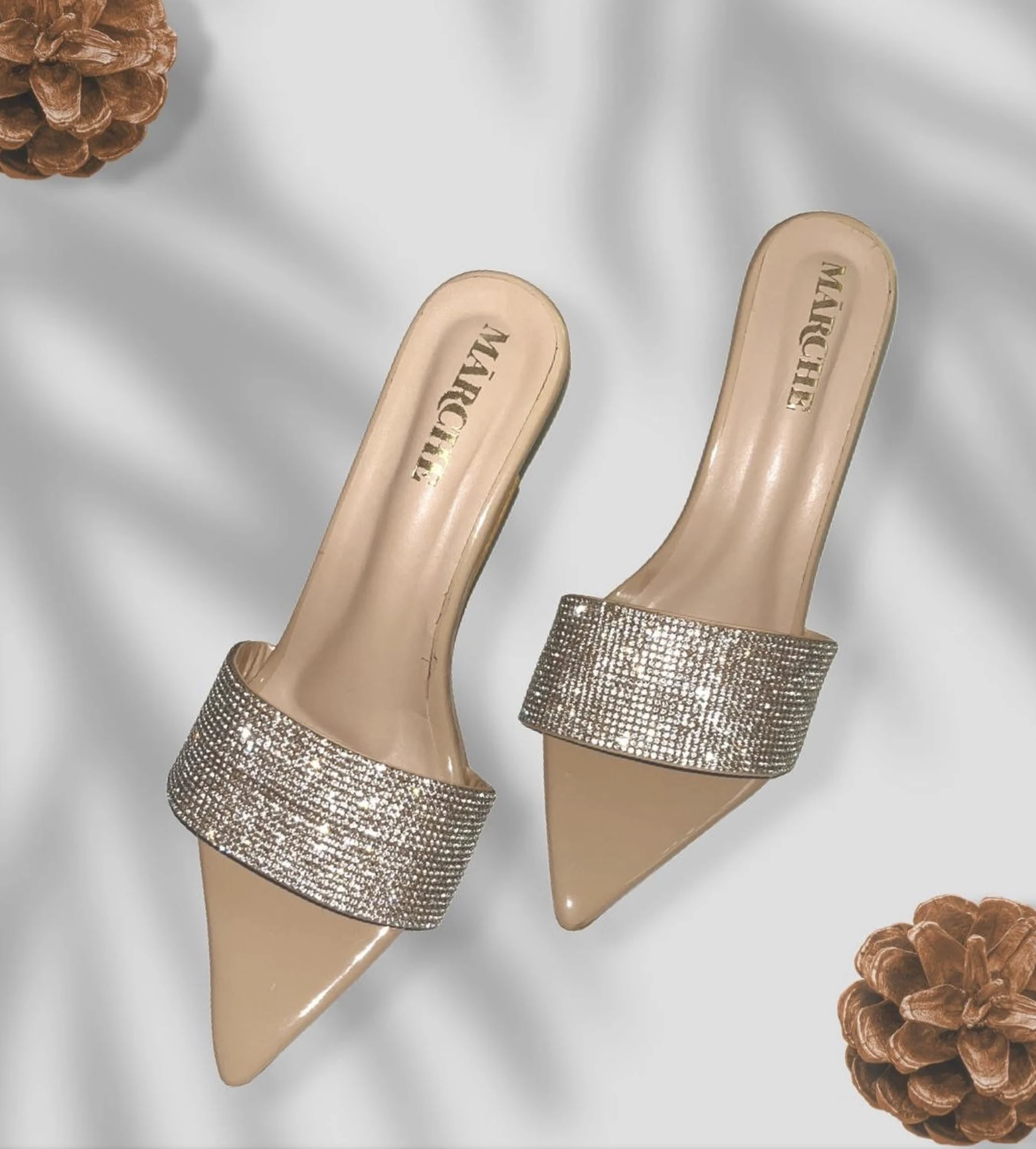 Mārche mules with the gold wordmark on the insole